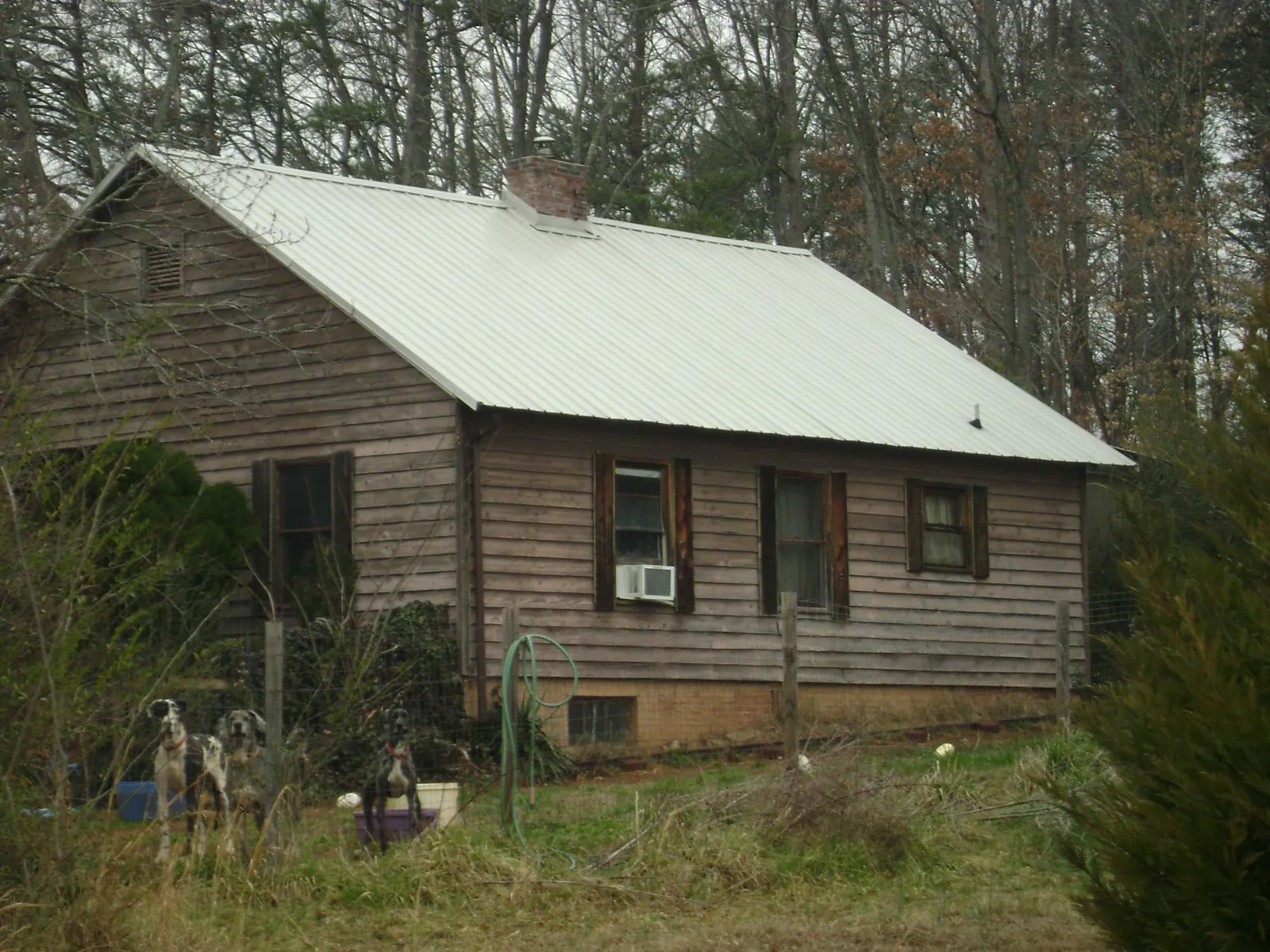 White metal roof on an old wood sided farmhouse, from a Metal Roof Installation job in Posen